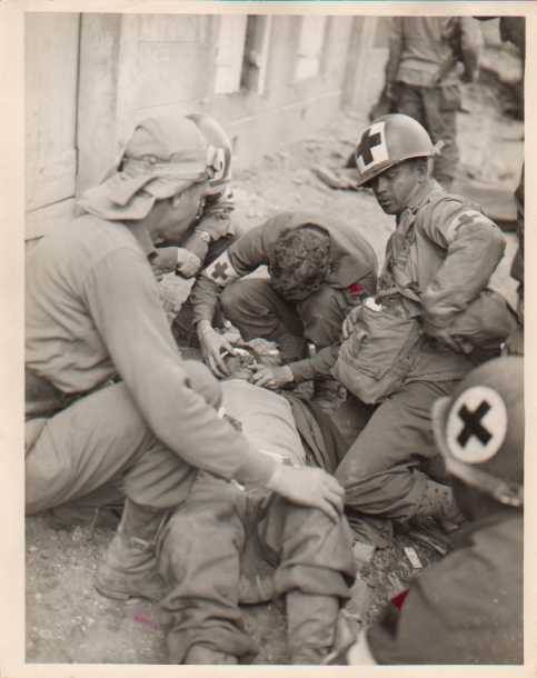 Airmen trying to help an injured colleague