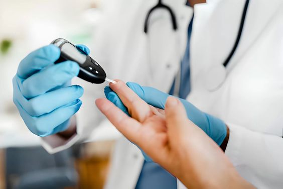 A doctor taking testing a patient's blood