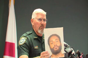A picture of Rick Wells with a photograph of Javontee Brice.