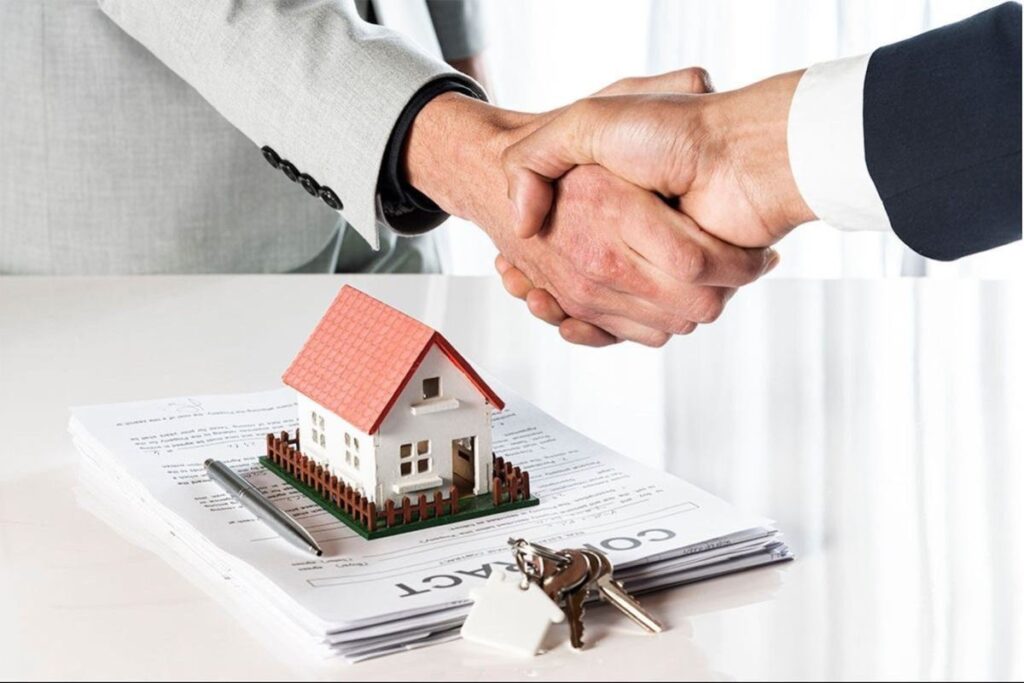 Client shaking house agent's hand.