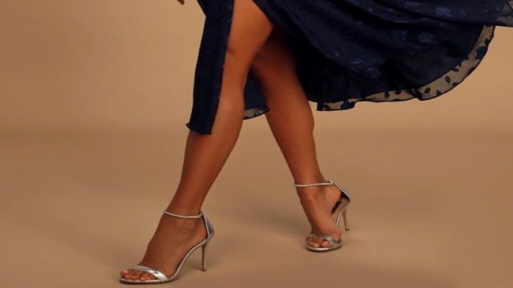 A navy dress and silver shoe