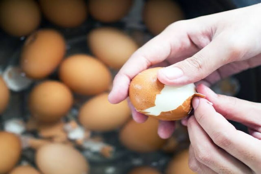 A Picture of Someone Peeling Boiled Eggs