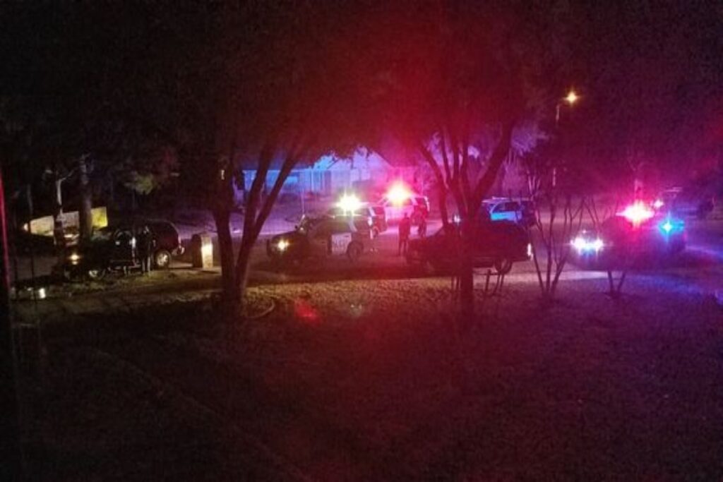 A picture of police cars outside a house