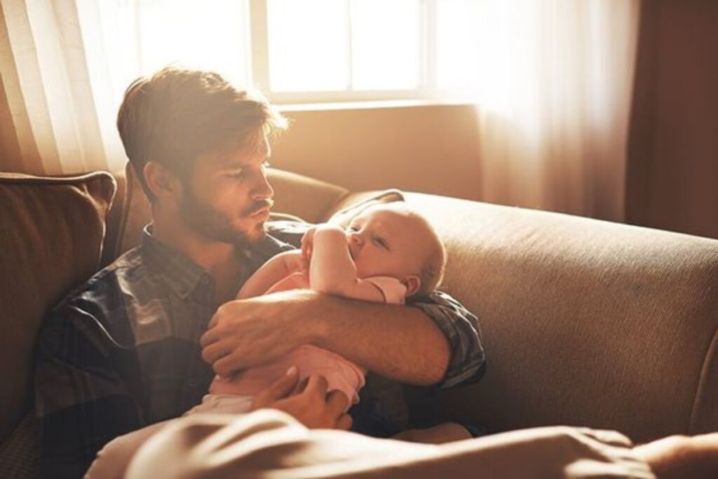 A picture of a man holding a baby