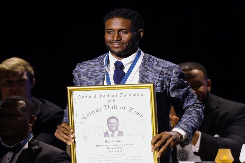 A picture of Reggie Bush with his induction award