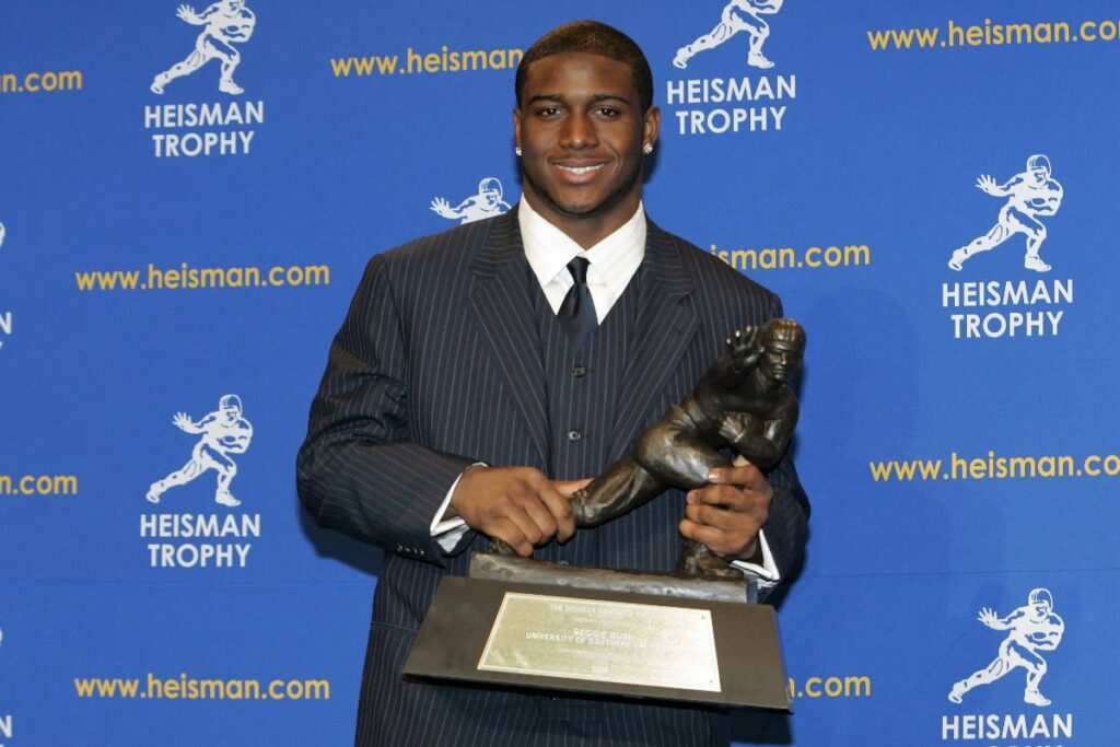 A picture of Reggie Bush with the Heisman trophy.