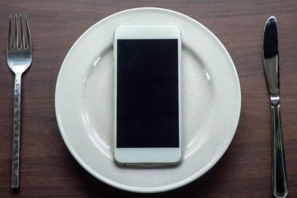 A picture of a phone placed in a plate.