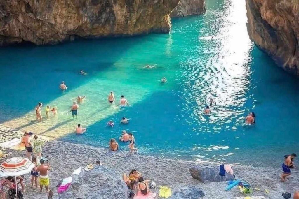 A picture of people swimming on a beach