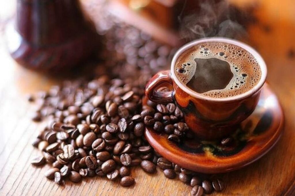 A picture of a cup of coffee and coffee beans