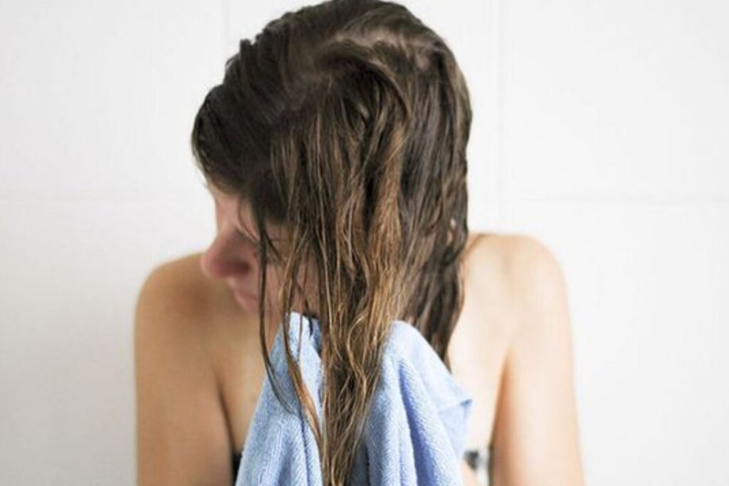 A picture of a woman drying her hair