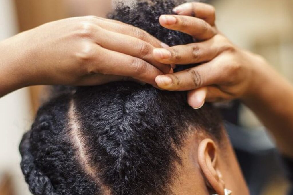 A picture of a woman self-braiding