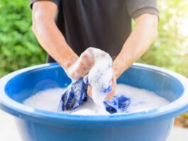 A picture of a person washing clothes by hand