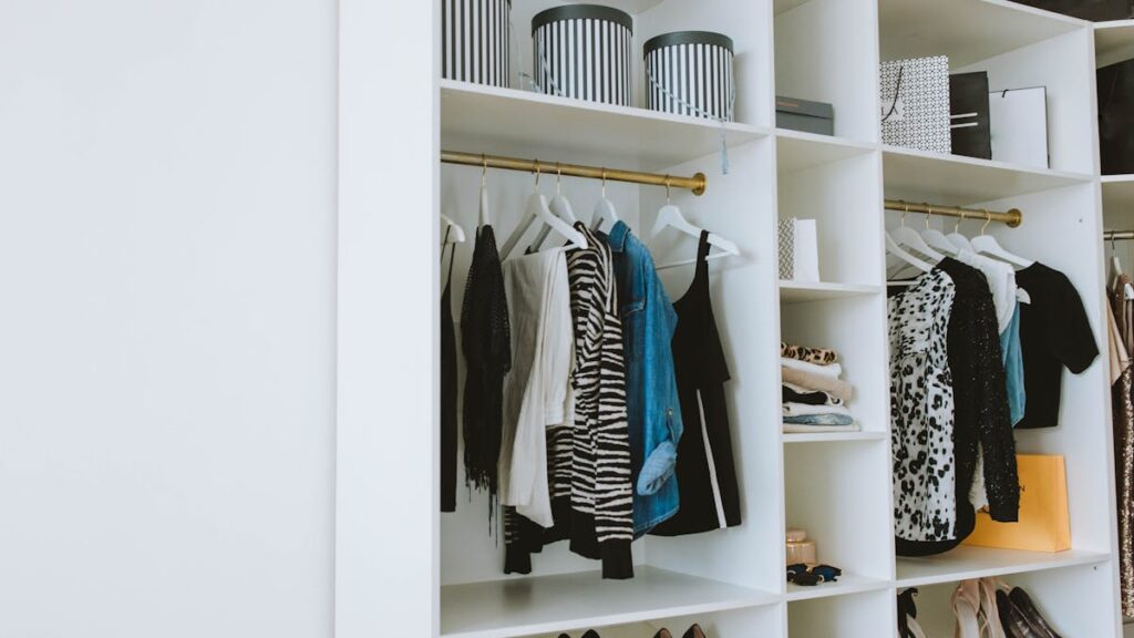 Clothes Hanged on White Wooden Cabinet
