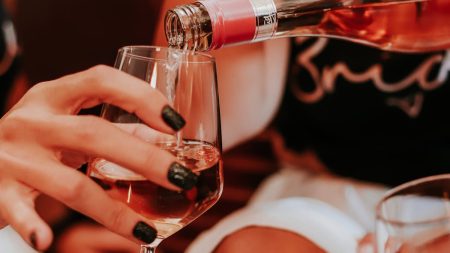 Crop anonymous ladies drinking wine during hen party