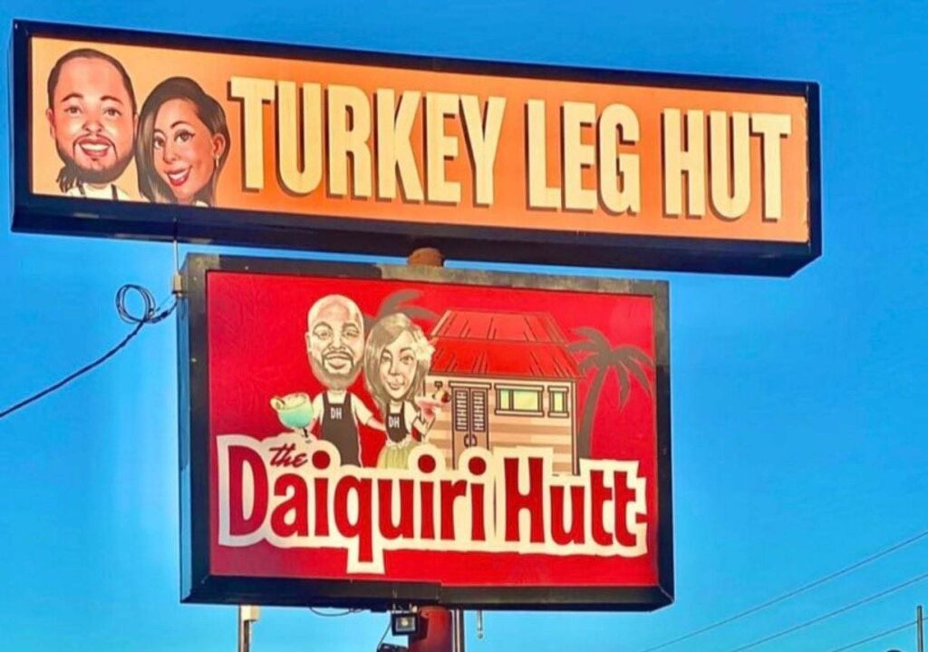 A picture of turkey leg hut and Daiquiri billboard