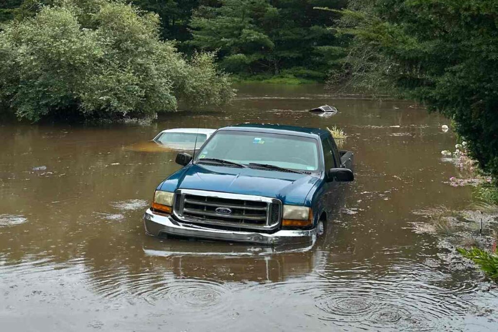 A picture of two vehicles stuck in the Connecticut Flooding