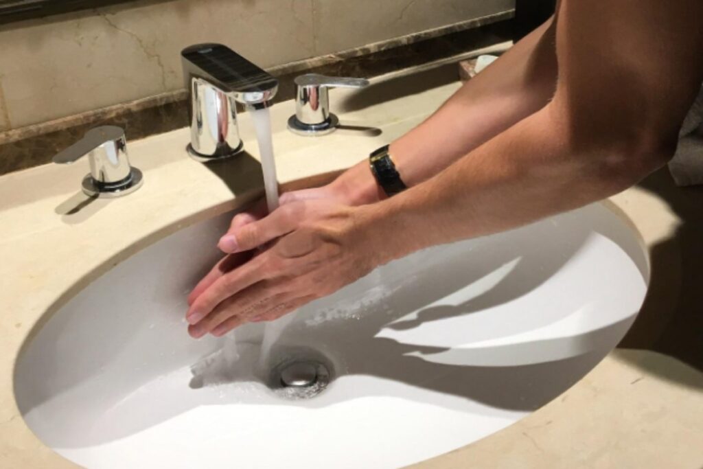 A picture of a person washing their hands in a sink