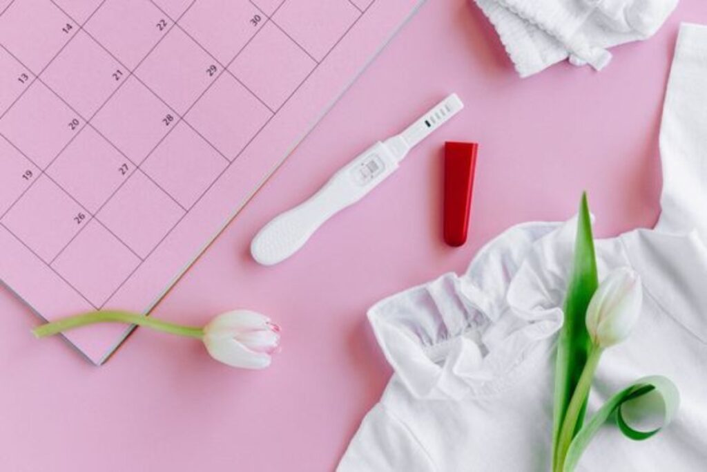 A picture of a pregnancy kit on a calender