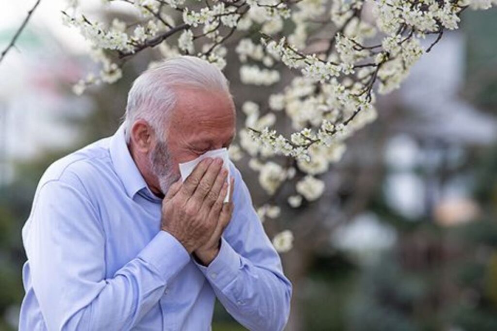 A picture of a man sneezing