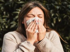 A picture of a woman sneezing