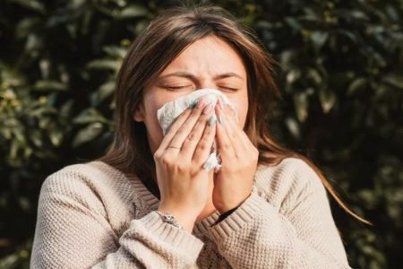 A picture of a woman sneezing