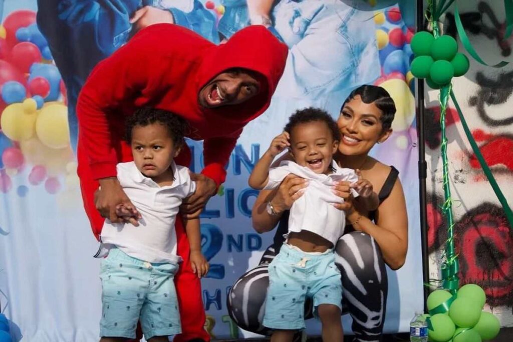 A picture of Nick Cannon, his twin sons, and their mother.