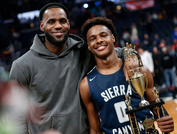 LeBron and Bronny James posing for a shot together