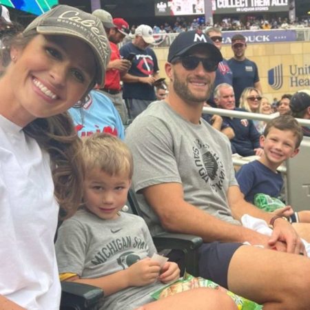 Kirk Cousins' wife posing with him and their kids at a football game