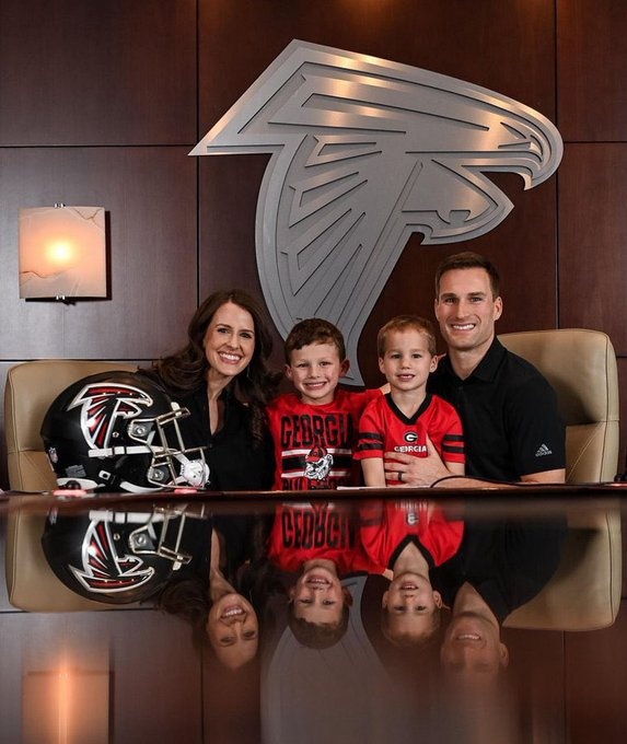 Kirk Cousins' wife posing with him and their kids