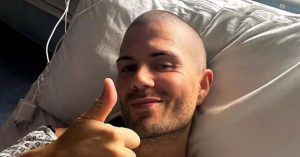 Max George giving a thumbs up in an hospital bed