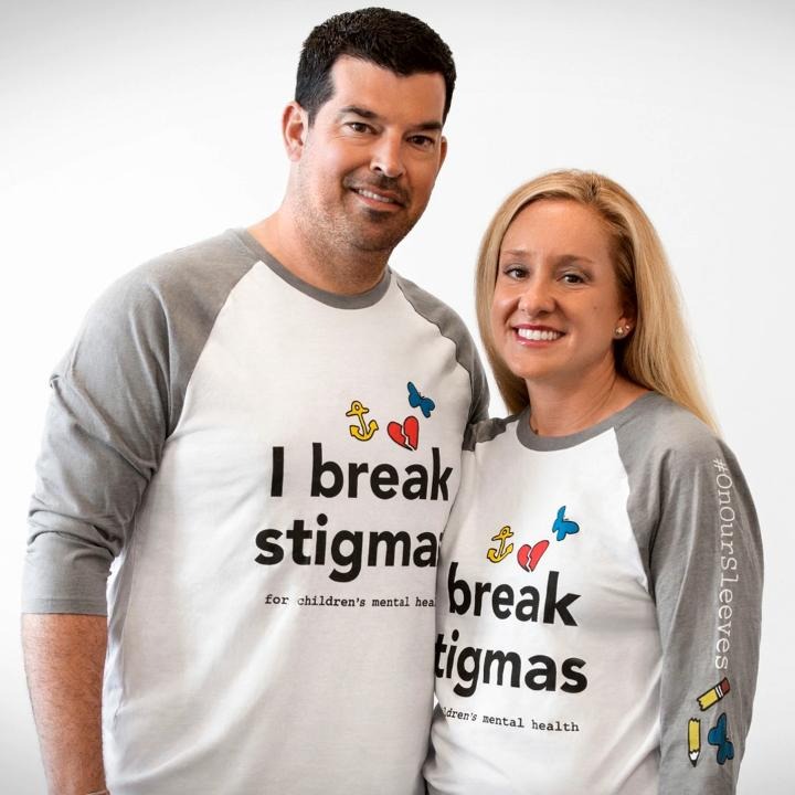 Ryan Day posing in matching tops with his wife