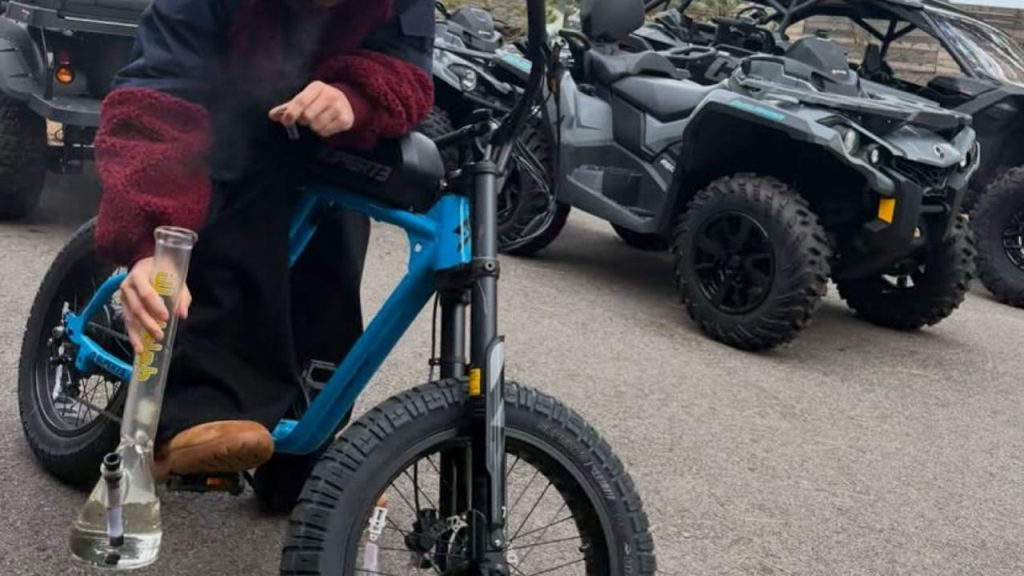 Image of Justin Bieber smoking, and seated on a power bike