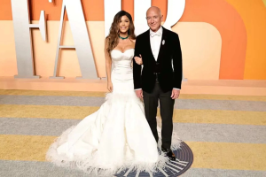 Jeff Bezos and Lauren Sanchez posing on the red carpet at Vanity Fair 2025