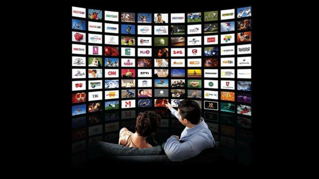 Couple watching a large TV screen displaying streaming platforms in the media industry